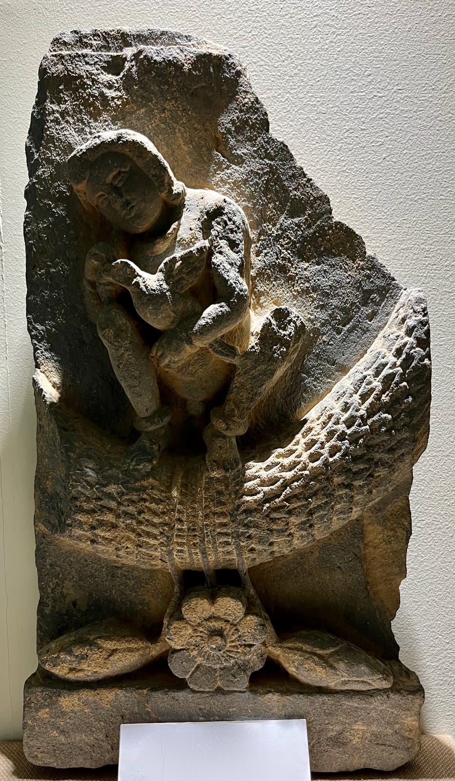 Putto seated on garland